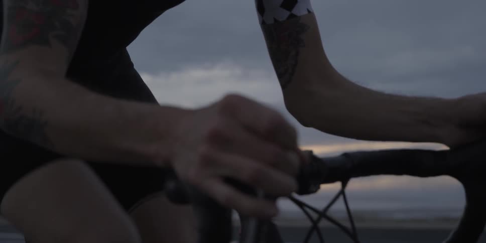 Close-up of a cyclist riding at sunset