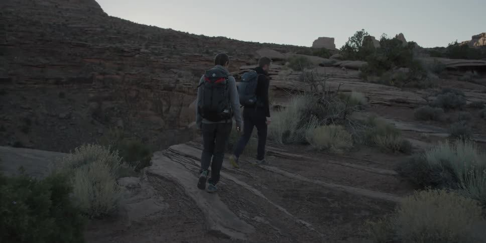 Two people are hiking on on a mountain top