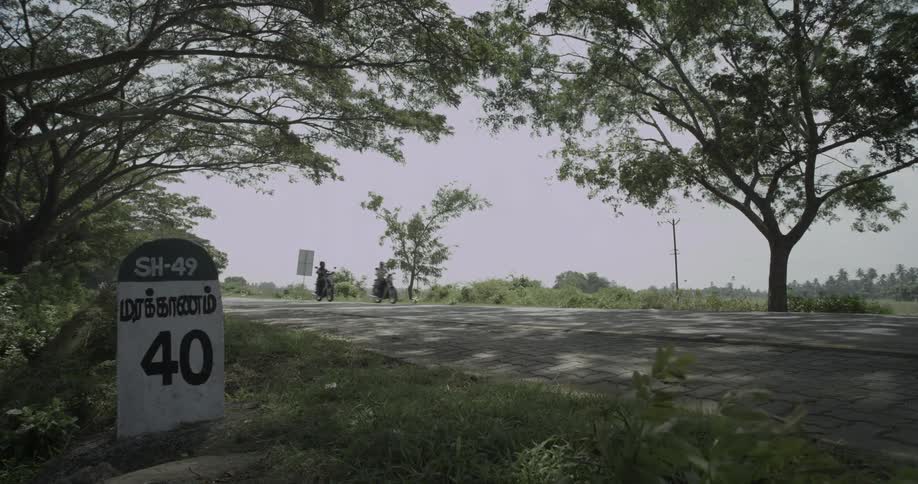 Two people riding motorcycles down a highway