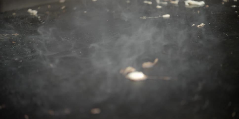 Smoke rises from burning material