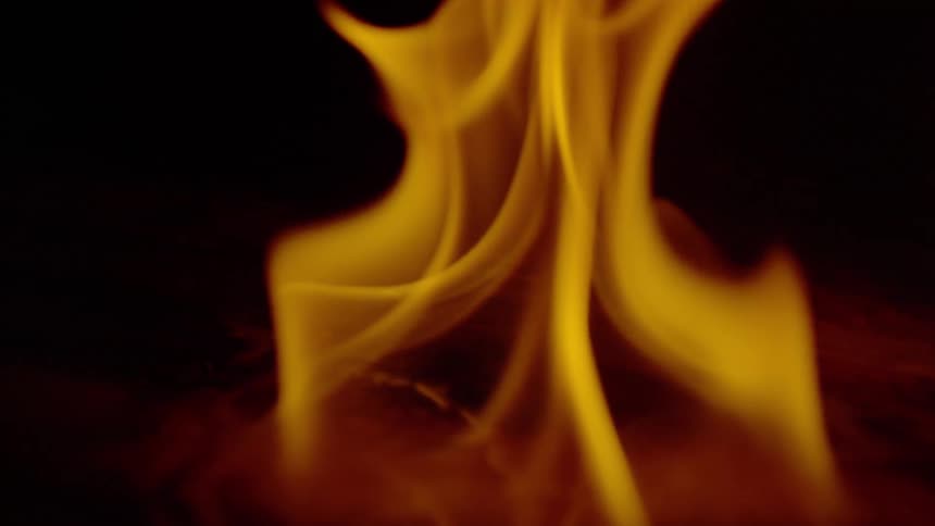 A close up of a flame burning wood