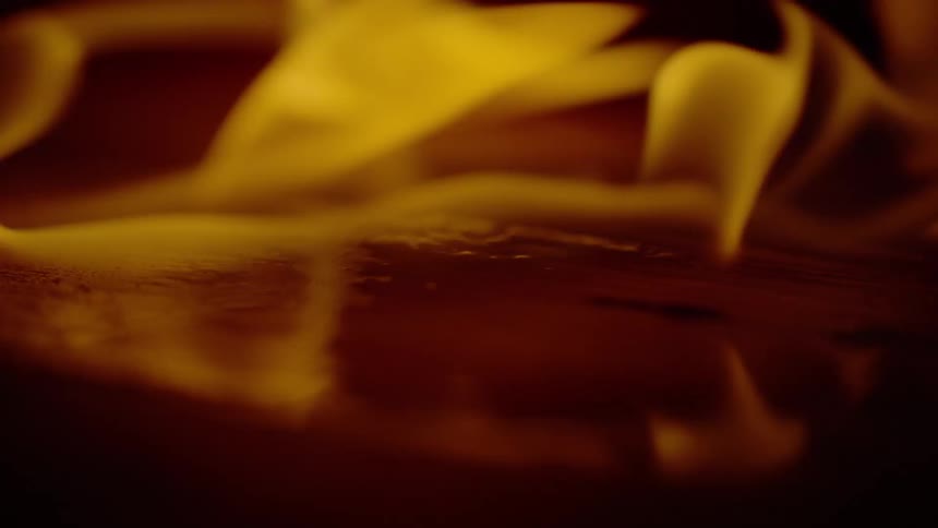 A close up of a flame burning wood