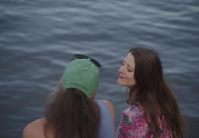 A couple kiss by the water