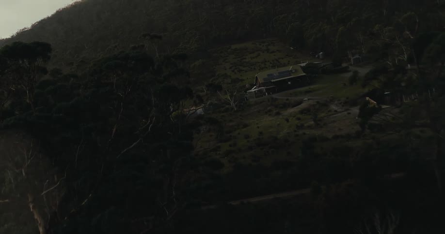 Farm house and facilities located in the middle of a forest in the mountains