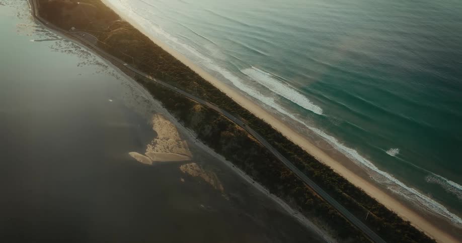 Aerial panorama of a road on an island surrounded by two beaches