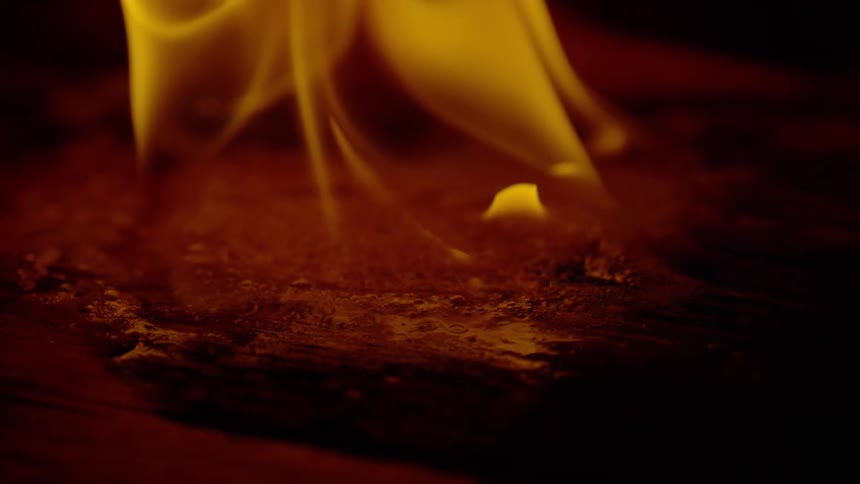 Yellow flame burning on a surface