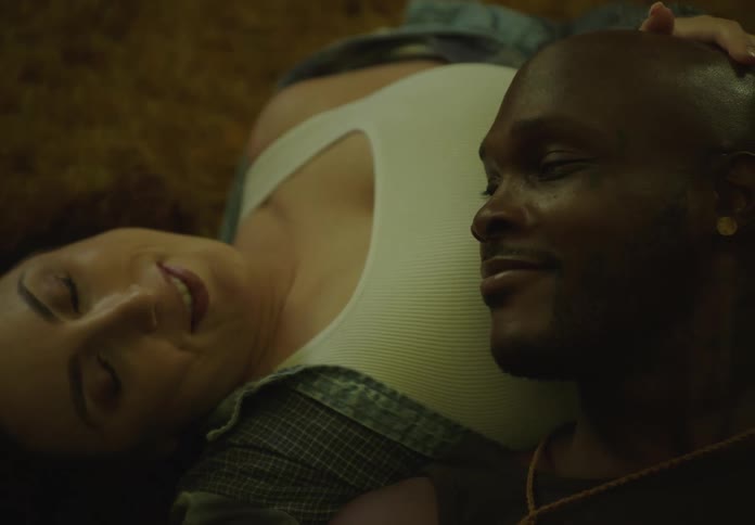 Man lying on a womans belly in a romantic way