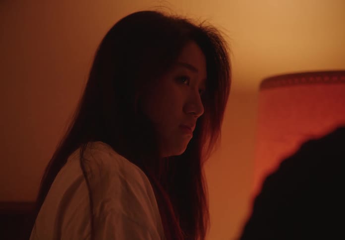 Portrait of a woman in a room with low lighting