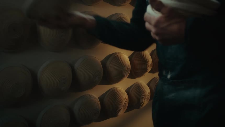 Man placing porcelain bowl on wall