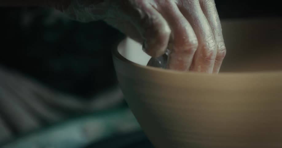 A sculptor is making a bowl