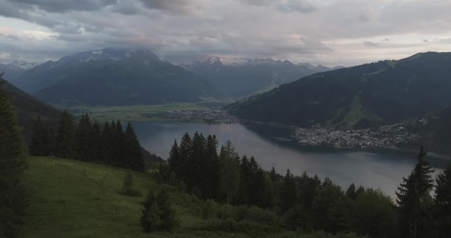 An aerial view of a coastal town nestled in the mountains next to a lake