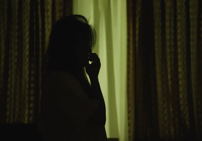 Silhouette of a woman in a dark room