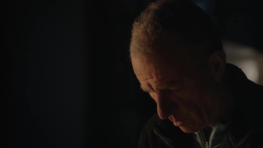 Portrait of an elderly man concentrated in an outdoor environment at night