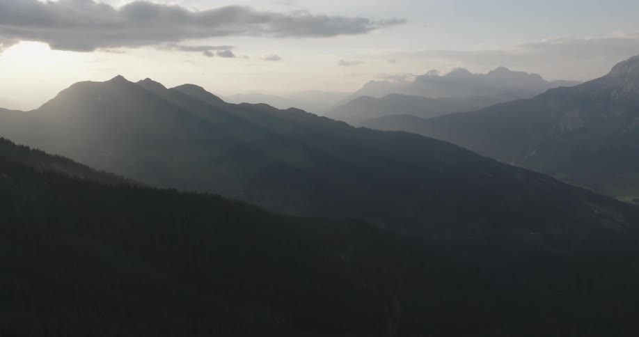 Aerial of a forested mountain range at dusk