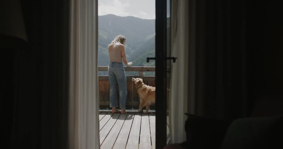 Golden retriever walking next to a blonde woman who strokes her fur