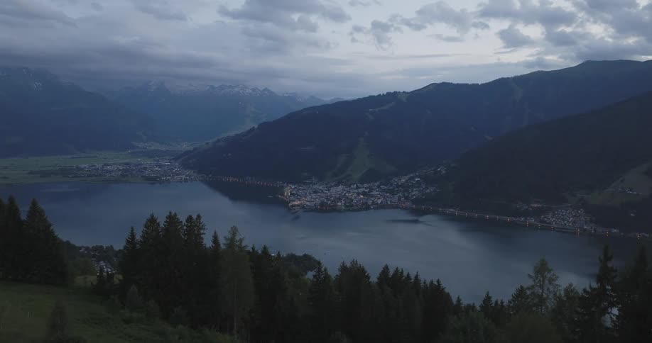 Panorama of a mountain valley with a lake in the background and coastal town