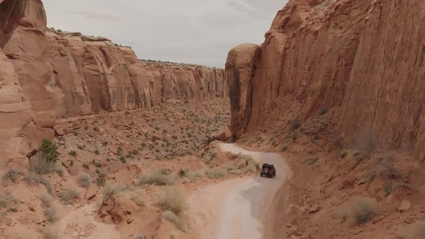 A truck is driving through the steep canyon
