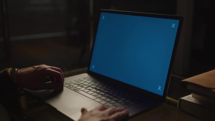 A person is sitting at their laptop