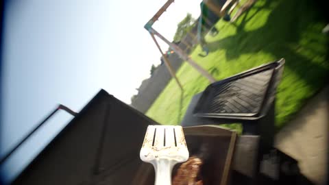 A steak is flipped on the grill
