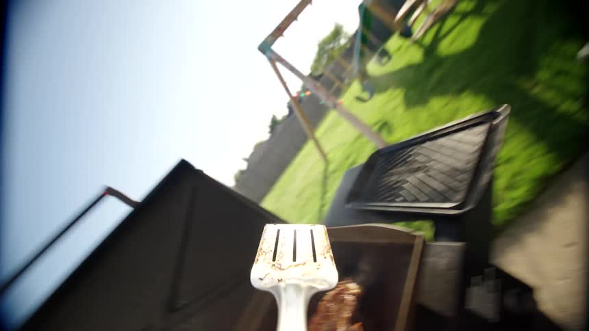 A steak is flipped on the grill