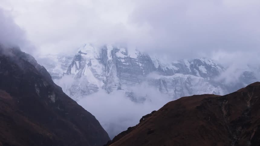 Fog fills valley between mountains on a cloudy winter day