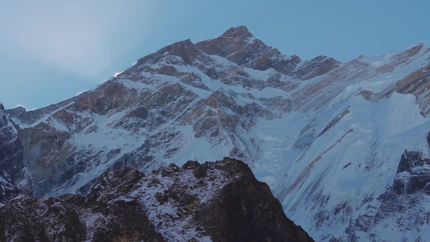 An aerial view of a mountain range covered with snow