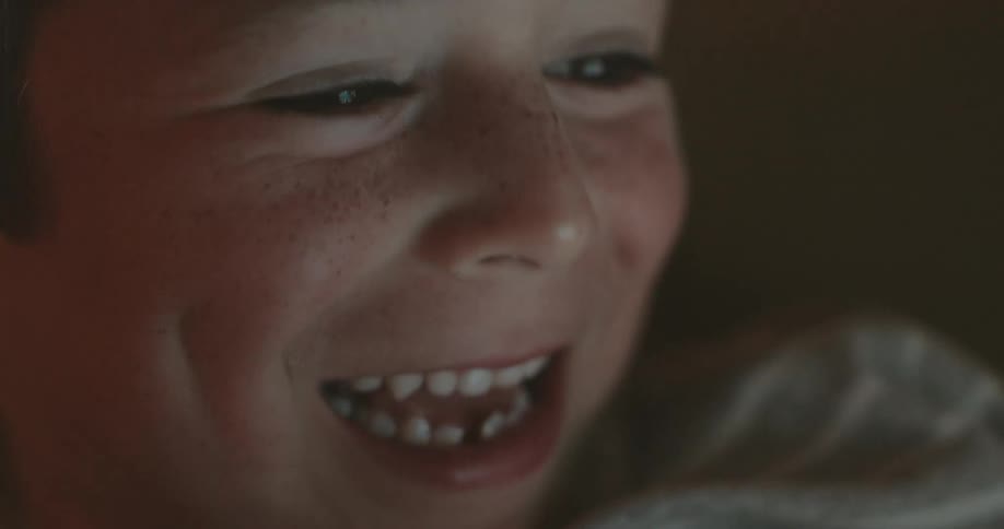 A child is talking and smiling