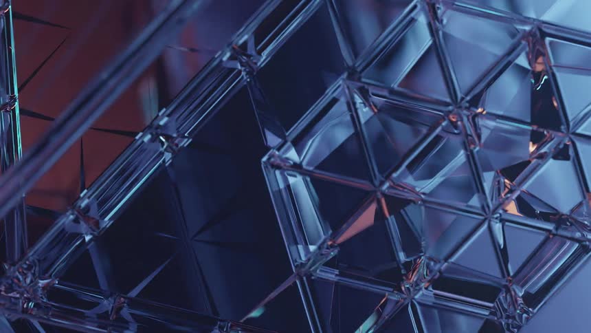 A glass structure that reflects and refracts light as it spins