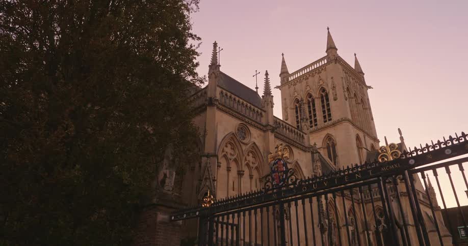 An old church sits behind black gates