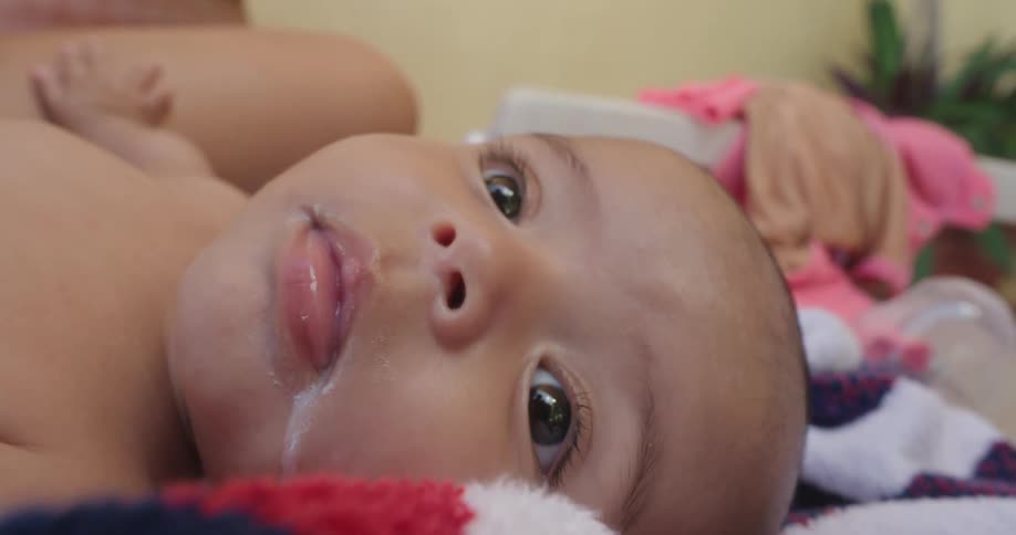 A view of a baby laying on a table