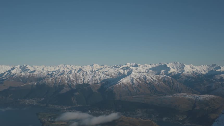 Snowcovered mountains under a darkening sky