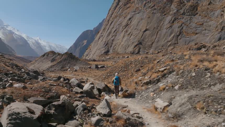 A man hiking outdoors in a mountain area