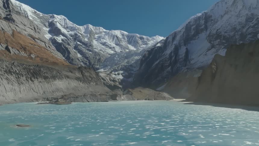 Frozen water on a coast nestled in a deep mountain valley