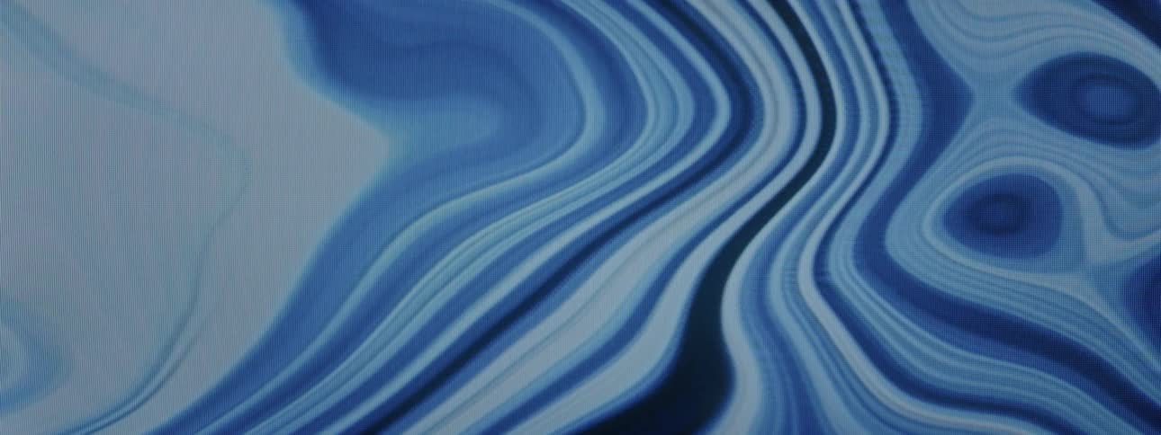 Blue liquid pools in and around itself before moving again to create a new pool elsewhere