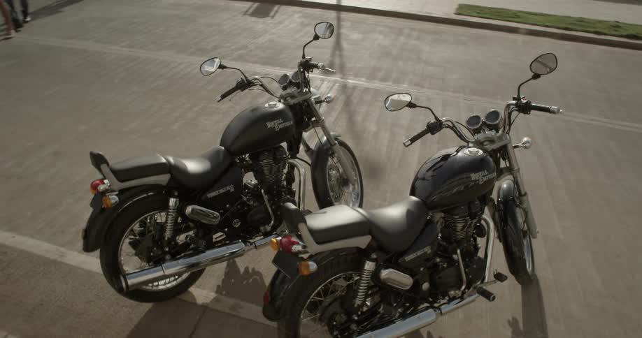 Two motorcycles are parked on the side of the road