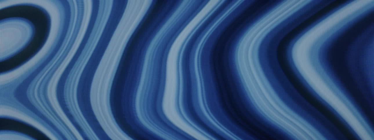 Waves in varying shades of blue move and bend into and away from each other