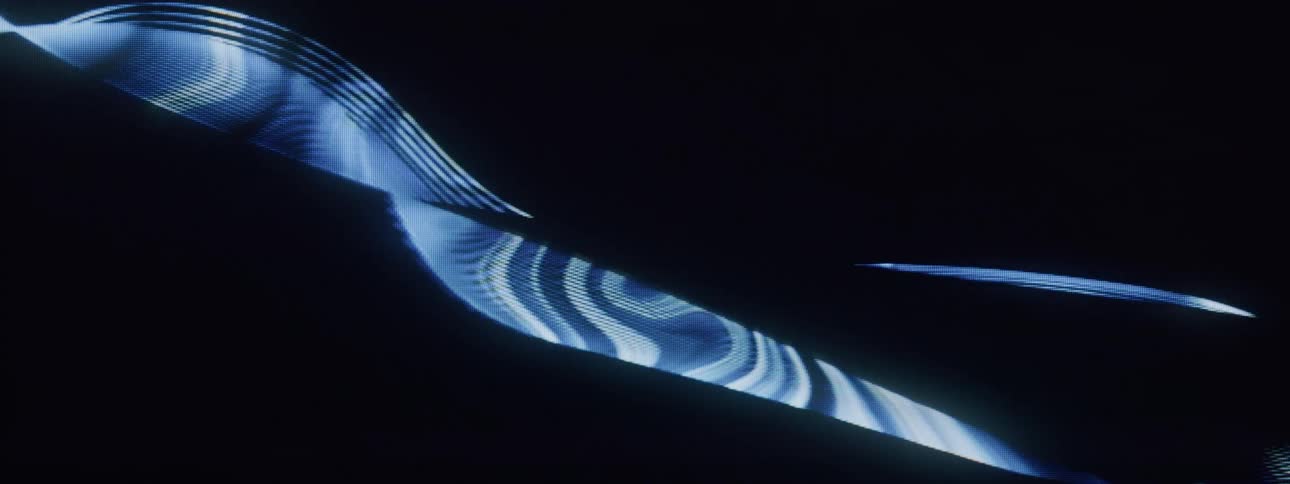 Flowing lines of a screensaver form patterns in blue and yellow against a black background