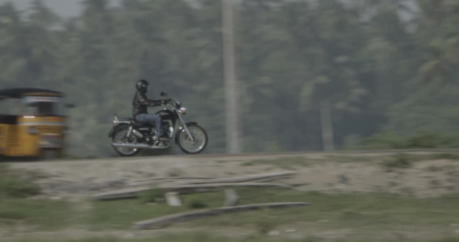 A motorcycle passes on the road ahead