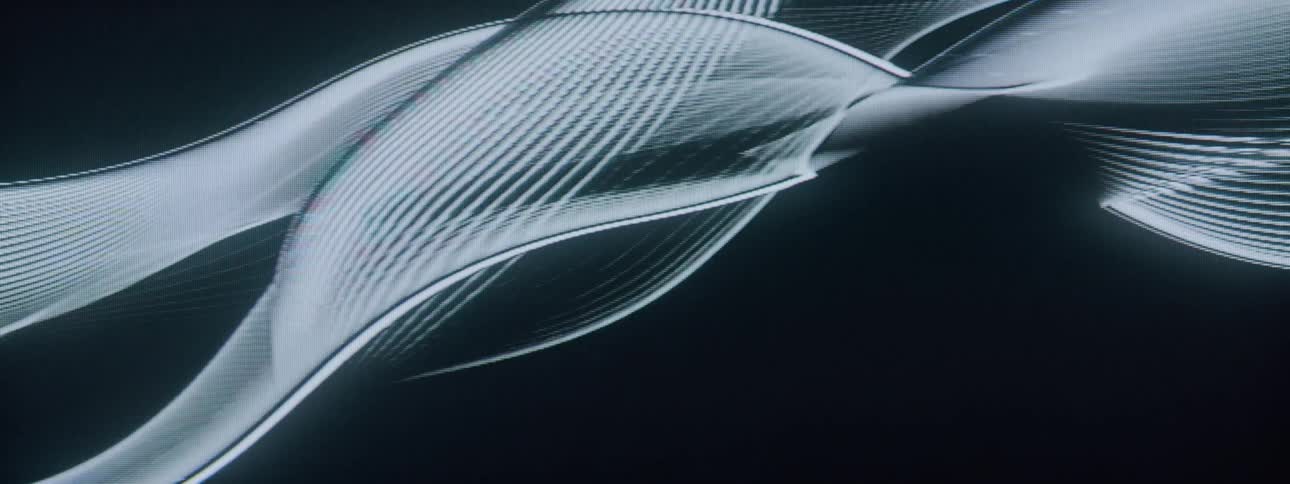 Projection of abstract lines in motion against a black background