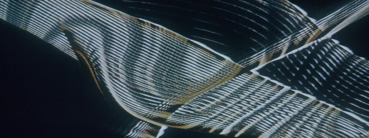 Lights move around on a dark background in various wave patterns