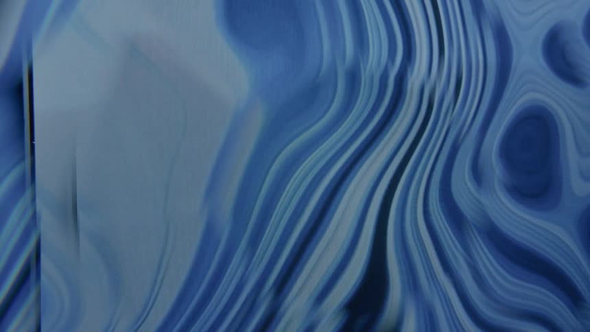 Liquid in different shades of blue ooze in and out around each other