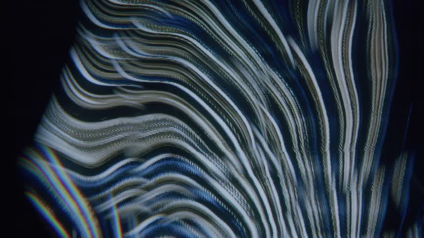 Blue and brown streaks curve around each other as static interrupts the flow