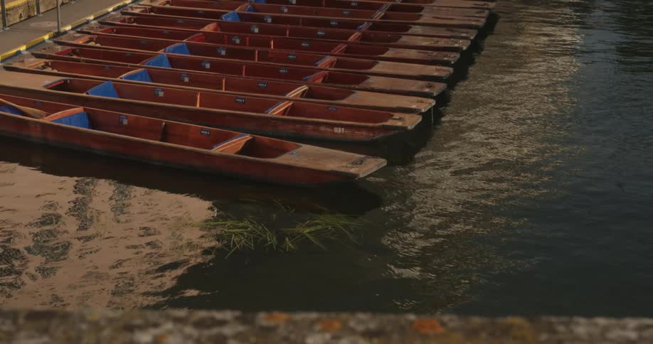 Narrow wooden canoes attacked at a dock