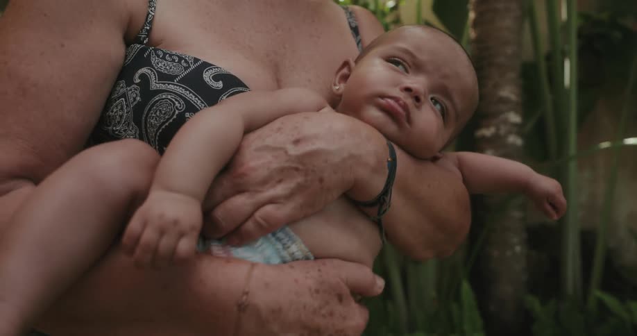 A woman is rocking a baby