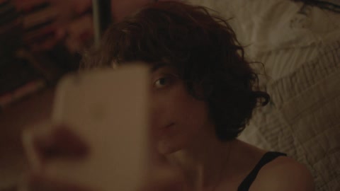 A woman taking a selfie with her iphone