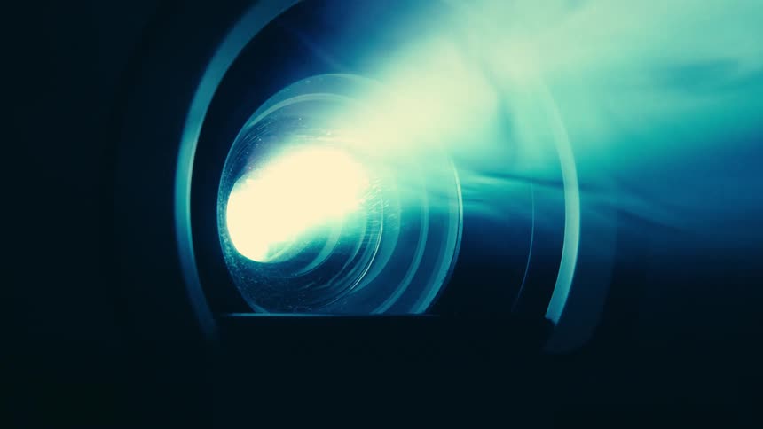 The projector is shining light in the dark