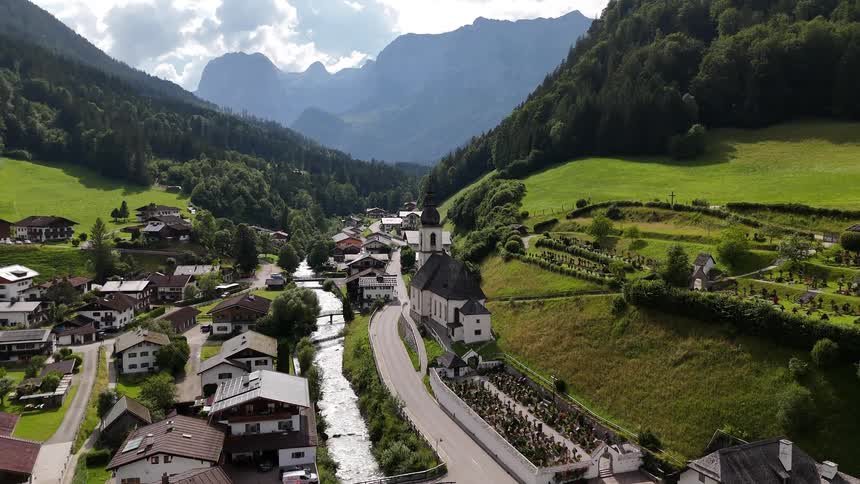 Aerial scene of a large village with a church built in a natural environment surrounded by mountains and vegetation