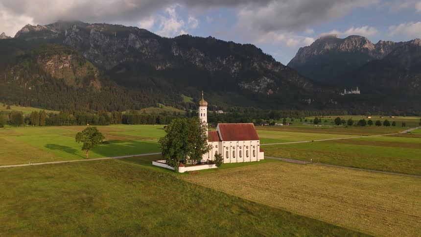 Church in the center of agricultural fields and surrounding mountains