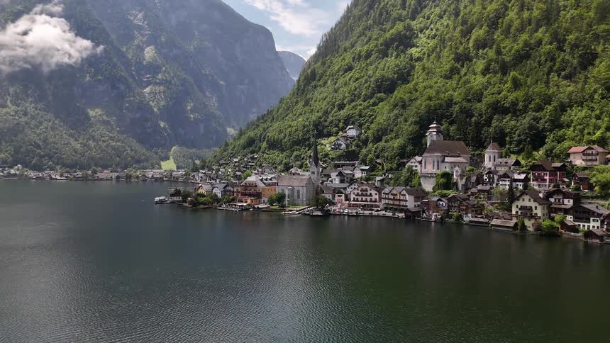 Picturesque lakeside village with steep mountains in the background