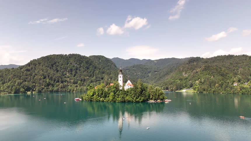 An aerial view of a church on an island in a lake